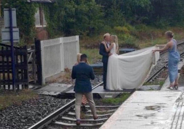 Plain stupid’ bride and groom pose for wedding photos on live train tracks